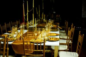 a long table with glasses and plates on it at Menlyn Mews BnB in Pretoria