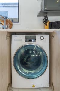 a washing machine with a blue plate on top of it at Modern Townhouse Cashel Street 2 bed 2 bath in Christchurch