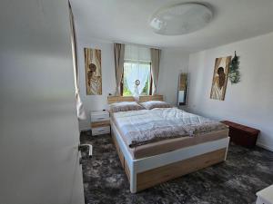 Schlafzimmer mit einem Bett und einem Fenster in der Unterkunft Harti Haus in Zeltweg