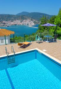 a swimming pool with a view of the water at Aegeon Hotel in Skopelos Town