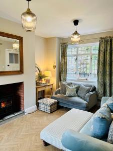 a living room with a couch and a fireplace at 5 - Idyllic Location - Great for Groups in Pont Sticill