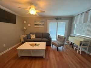 a living room with a couch and a table at Great Vibes in Panama City Beach