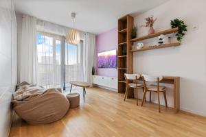 a living room with a table and chairs at LAM Lavender - FREE PARKING in Bratislava