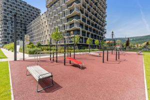 an empty playground with benches and a building at LAM Lavender with Free Parking in Bratislava