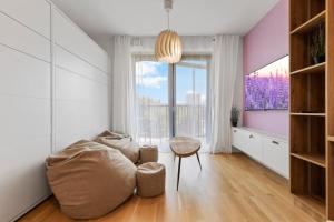 a living room with a couch and a table at LAM Lavender with Free Parking in Bratislava