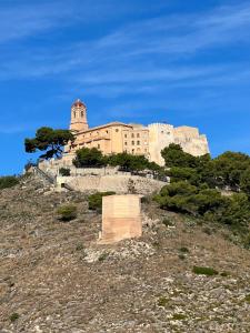 a large building on top of a hill at Apartamento “Rubens” in Cullera
