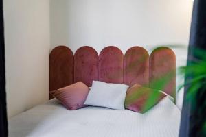 a bed with a wooden head board and two pillows at Mokotów Premium Studio in Warsaw
