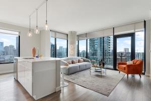 a kitchen and living room with a view of a city at Xl apartments at the GoldCoast- Cloud9-833 in Chicago