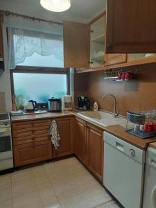 a kitchen with a sink and a window at Didi House in Sandanski