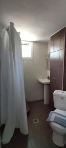 a bathroom with a toilet and a sink at Francesca Studios in Potos