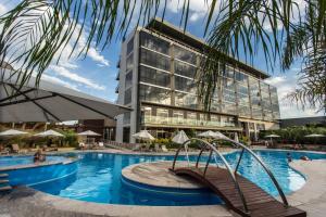 a hotel with a swimming pool in front of a building at Esplendor by Wyndham Mendoza in Mendoza