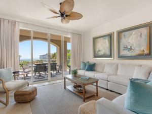 a living room with a couch and a ceiling fan at San Remo Condominium 209 by Newman-Dailey in Santa Rosa Beach