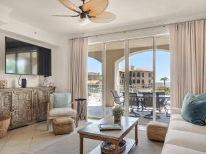 a living room with a couch and a table at San Remo Condominium 209 by Newman-Dailey in Santa Rosa Beach