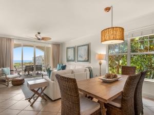 a living room with a table and chairs and a couch at San Remo Condominium 209 by Newman-Dailey in Santa Rosa Beach +63 photos