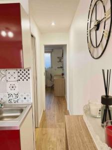 a kitchen with a large clock on the wall at Appartement Ensoleillé à 15 minutes de Paris in Vitry-sur-Seine