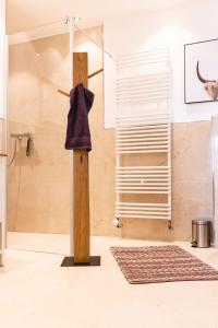 a bathroom with a shower with a towel on a pole at Auszeit Altenhorst in Schalksmühle