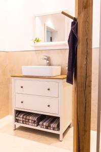 a bathroom vanity with a sink and a mirror at Auszeit Altenhorst in Schalksmühle