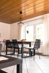 a dining room with a table and two chairs at Auszeit Altenhorst in Schalksmühle