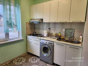 a kitchen with a washing machine and a sink at Bagman House in Ganja