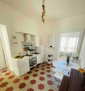 a kitchen with a counter and a table in a room at Casetta 1870 in Ortona