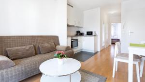 a living room with a couch and a table at Apartments an der Uniklinik in Freiburg im Breisgau