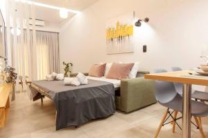 a living room with a bed and a table at Elektra Luxury Apartment in Alexandroupoli