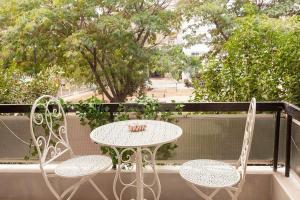a table and two chairs on a balcony at Elektra Luxury Apartment in Alexandroupoli
