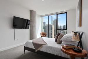 a bedroom with a bed and a large window at Aurelien Spacious Apartments in the Heart of Gold Coast in Chicago