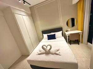 a bedroom with a bed with a heart decoration on it at Axon Residence By Perkasa Suites in Kuala Lumpur