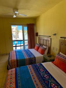 Postel nebo postele na pokoji v ubytování Siesta Suites Boutique Hotel