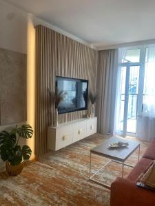 a living room with a television on a dresser at Bel Mare Resort ekskluzywny apartament dla wymagających klientów in Międzyzdroje