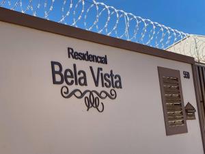 a sign on the side of a building at Apart. Bela Vista in Pôrto Ferreira