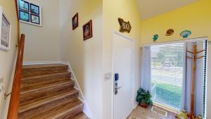 a staircase in a home with yellow walls at Cozy 2BR Villa by Litchfield Beach - Heron Marsh in Pawleys Island