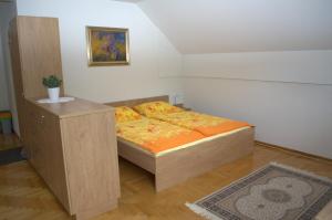 a small bedroom with a bed and a table at Apartment Brumec in Bohinj