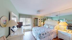 a bedroom with a bed and a large mirror at Cozy 2BR Villa by Litchfield Beach - Heron Marsh in Pawleys Island +19 photos