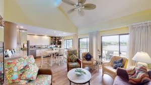 a living room with a couch and chairs and a kitchen at Cozy 2BR Villa by Litchfield Beach - Heron Marsh in Pawleys Island
