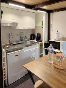a kitchen with a table and a counter top at Cosy Appart Centre de Paris in Paris