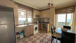a kitchen with a sink and a dishwasher at MİLA SUİTE in Trabzon