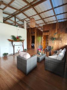 a living room with two couches and a wooden floor at Cabañas Arrecifes in El Valle