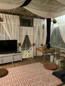 a living room with a flat screen tv and a rug at شاليه ماربيا ١ in Jeddah