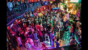 an overhead view of a crowd of people in a bar at Dreamy luxury duplex villa with a special view and 300 meters of private garden in Alanya +173 photos