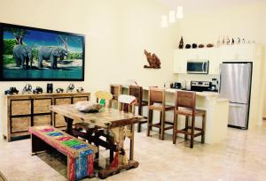 a kitchen and dining room with a table and a kitchen with a kitchen at The Elephant Castle Beach Front Penthouse in Manuel Antonio