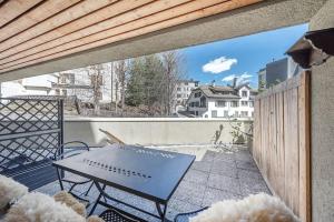 a patio with a table on a balcony at Studio centralissimo a St. Moritz in St. Moritz