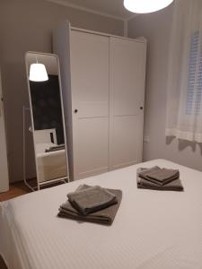 Posteľ alebo postele v izbe v ubytovaní Apartmani Sidro