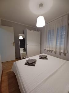 Posteľ alebo postele v izbe v ubytovaní Apartmani Sidro