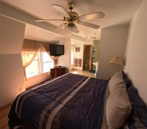 a bedroom with a bed and a ceiling fan at Sunset Inn in South Haven