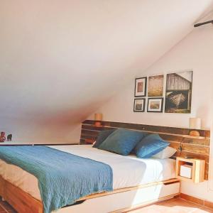 a bedroom with a large bed with blue pillows at Selwo Studio in Estepona