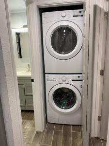 a washing machine and a washer and dryer in a bathroom at Betterplace 2-Bedooms Walk to Armature Works and Downtown Tampa in Tampa