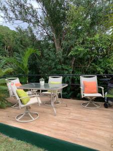 a patio with a table and four chairs at Sugarfields Villa in Jolly Harbour