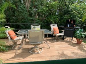 a group of chairs and tables on a patio at Sugarfields Villa in Jolly Harbour